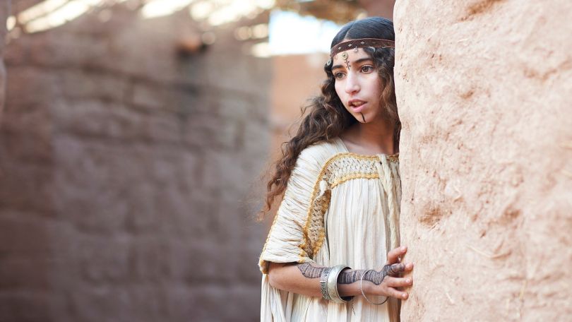 Movie still of female fortune teller at street corner